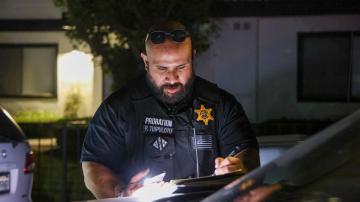 Probation Officer outside filling paperwork